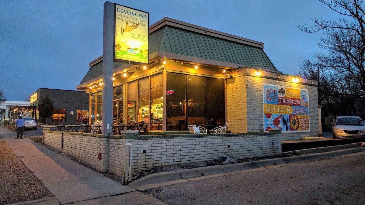 College Hill Deli & Catering storefront on East Douglas Avenue at dusk